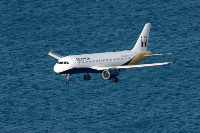 Monarch airlines jet on final approach to Gibraltar over Mediterranean sea