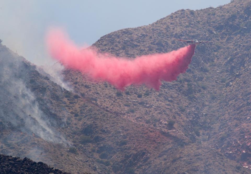 A Cal Fire aircraft drops fire retardant on the Tuscany Fire in Palm Springs on June 16.