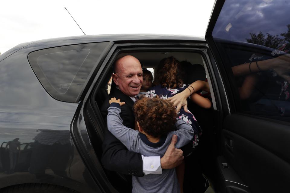 EDS NOTE : SPANISH LAW REQUIRES THAT THE FACES OF MINORS ARE MASKED IN PUBLICATIONS WITHIN SPAIN. Accompanied by family members, former Venezuelan military spy chief, retired Maj. Gen. Hugo Carvajal, center, enters into a car after walking out of prison in Estremera, outskirts of Madrid, Spain, Sunday, Sept. 15, 2019. Spain's National Court has rejected the extradition to the United States of a former Venezuelan military spy chief accused of drug smuggling and other charges. Within hours of Monday's ruling, the court released retired Maj. Gen. Hugo Carvajal, who claimed that the extradition request was politically motivated. (AP Photo/Manu Fernandez)