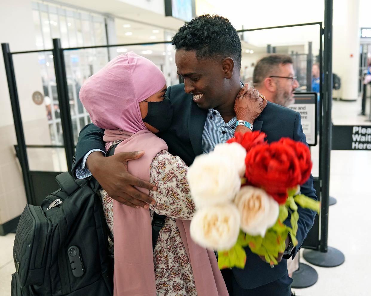 Afkab Hussein smiles while hugging his wife, Rhodo Abdirahman, who arrived from Kenya at the John Glenn Columbus International Airport on Thursday with their two sons. When Hussein arrived in the U.S. in 2015, his pregnant wife was still in the Kenyan refugee camp where they met, but they were assured that Abdirahman could join Hussein soon after he left. That was almost seven years ago.