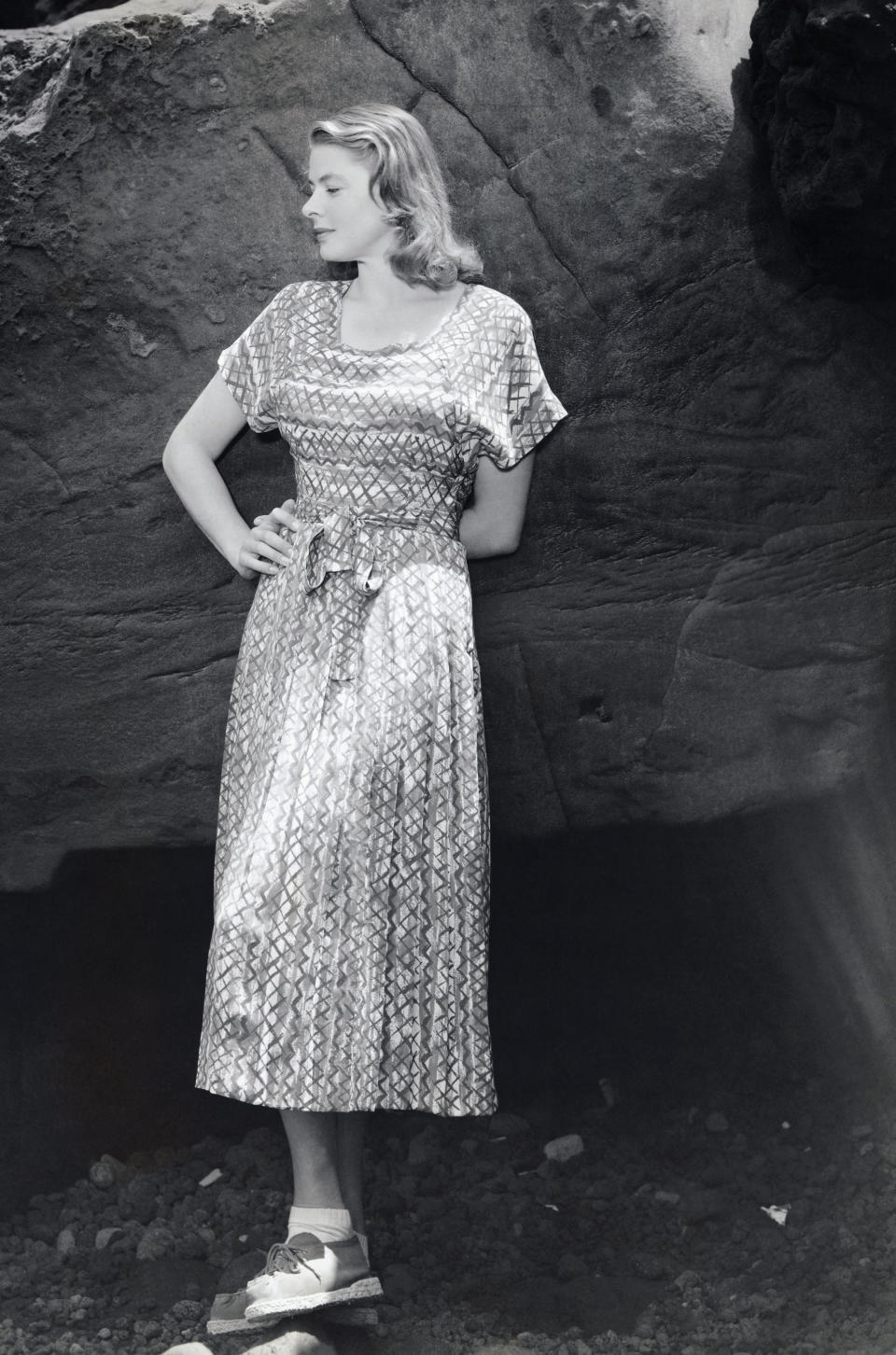 Ingrid Bergman poses near a rock, circa 1949.