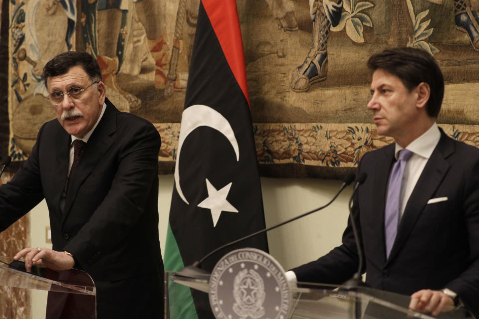 CORRECTS NAME OF LIBYA'S PRIME MINISTER TO FAYEZ SARRAJ -- FILE - In this Saturday, Jan. 11, 2020 file photo, Libya's Prime Minister Fayez Sarraj, left, holds a joint press conference with Italian Premier Giuseppe Conte after their meeting at Chigi palace, in Rome. Russia is convening Libya’s rival leaders for peace talks on Monday, Jan. 13, 2020, a diplomatic push closely coordinated with Turkey. Russia and Turkey, accused of exacerbating the fighting by backing dueling sides, have emerged as major players in Libya’s war, outmaneuvering European powers that pressed for peace as the fighting in the strategic, oil-rich country only accelerated. (AP Photo/Gregorio Borgia, File)