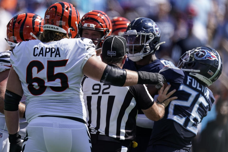 Umpire Bryan Neale (92) separates players midfield during the first half of an NFL football game between the Tennessee Titans and the Cincinnati Bengals, Sunday, Oct. 1, 2023, in Nashville, Tenn. (AP Photo/George Walker IV)