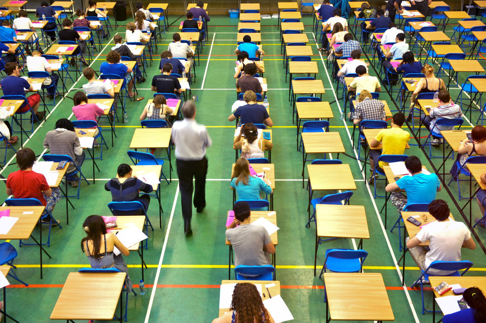 A-level students sit an A-level maths exam inside a sports hall