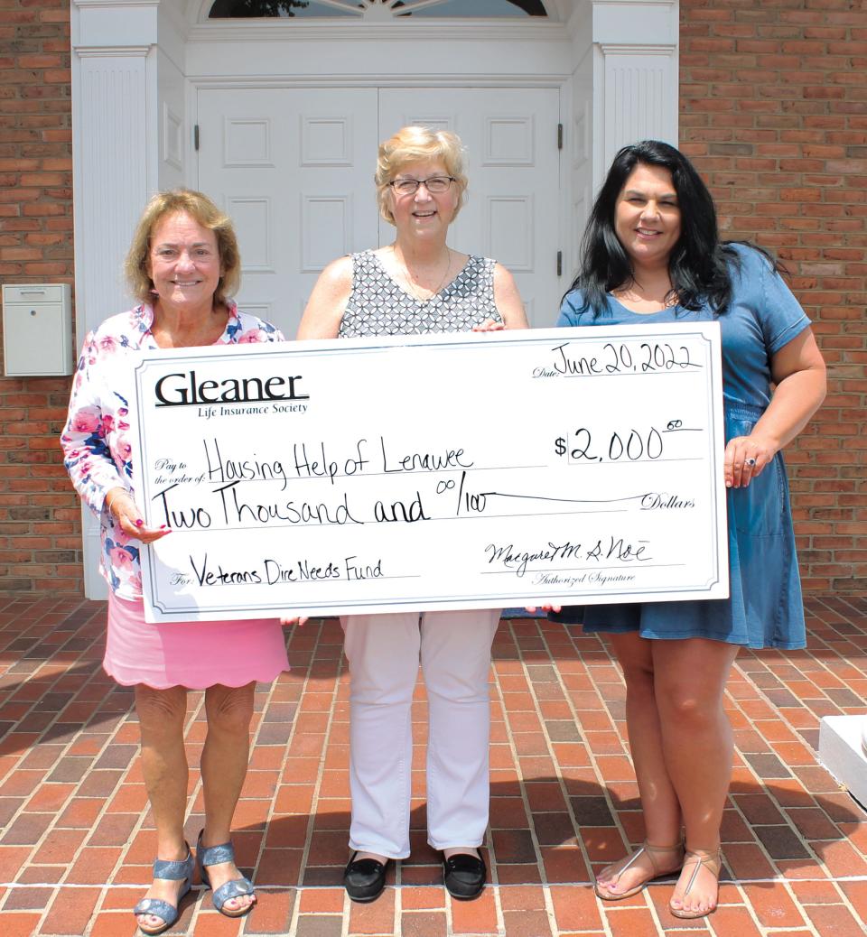 Gleaner Life Interim President and CEO Margaret M.S. Noe, left, and Vice President Jaime Linden, right, present $2,000 to Lynne Punnett, center, interim executive director of Housing Help of Lenawee on June 20. The money was raised through Gleaner Life Insurance Society’s Flag Day flag exchange.