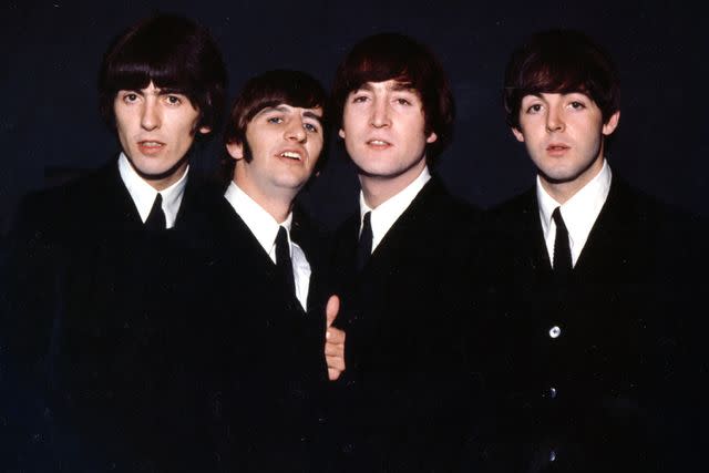 <p>Michael Ochs Archives/Getty </p> The Beatles pose for a portrait wearing suits in 1964