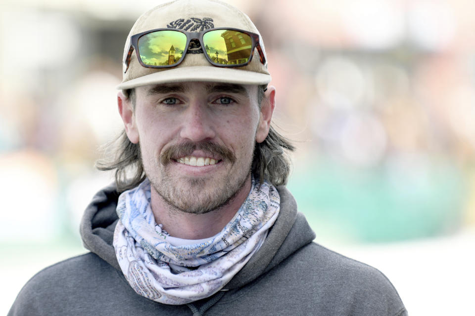 Skijoring competitor Nick Burri poses in Leadville, Colo., on Saturday, March 2, 2024. Skijoring draws its name from the Norwegian word skikjoring, meaning "ski driving." It started as a practical mode of transportation in Scandinavia and became popular in the Alps around 1900. Today's sport features horses at full gallop towing skiers by rope over jumps and around obstacles as they try to lance suspended hoops with a baton, typically a ski pole that's cut in half. (AP Photo/Thomas Peipert)