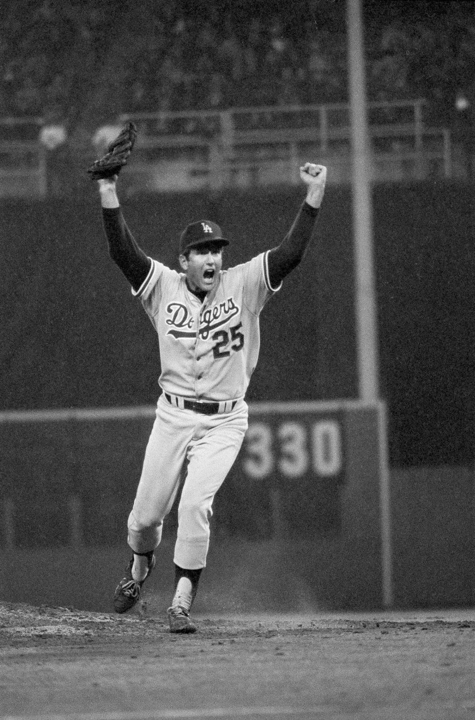 FILE - Los Angeles Dodgers pitcher Tommy John yells as he charges off the mound after the final out in 4-1 victory over the Philadelphia Phillies to win the National League playoffs in Philadelphia, Oct. 8, 1977. Almost 50 years ago, on Sept. 25, 1974, Dr. Frank Jobe reconstructed a torn ulnar collateral ligament in John's left arm. It was a pioneering achievement for Jobe and a lifeline for John, who went from a career-ending injury to 14 more years in the majors — and an eponymous connection to sports medicine that would live on long past his playing days. Tommy John surgery.(AP Photo/File)