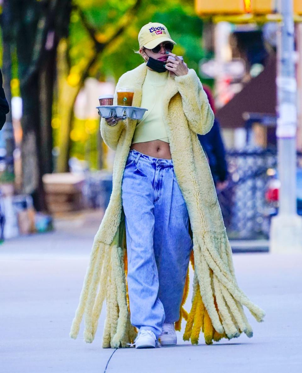 <p>Hailey did a coffee run in New York in that Bottega Veneta teddy shearling yellow coat (which looks as practical for the weather as it is on trend), matching cap, baggy jeans and sneakers.</p><p><a class="link " href="https://www.farfetch.com/uk/shopping/women/bottega-veneta-teddy-shearling-coat-item-15490284.aspx" rel="nofollow noopener" target="_blank" data-ylk="slk:SHOP NOW;elm:context_link;itc:0;sec:content-canvas">SHOP NOW</a> Bottega Veneta teddy shearling coat</p>