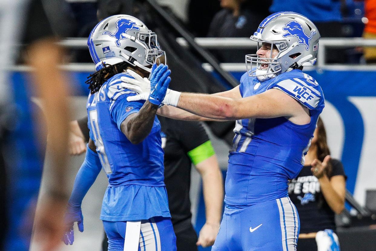 Detroit Lions tight end Sam LaPorta celebrates a touchdown against Denver Broncos with wide receiver Jameson Williams during the first half at Ford Field in Detroit on Saturday, Dec. 16, 2023.