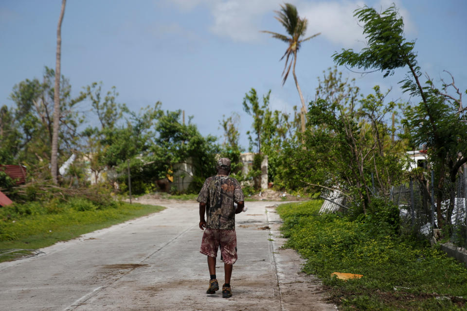 <p>A man walks down a street at Codrington on the island of Barbuda just after a month after Hurricane Irma struck the Caribbean islands of Antigua and Barbuda, October 7, 2017. REUTERS/Shannon Stapleton </p>