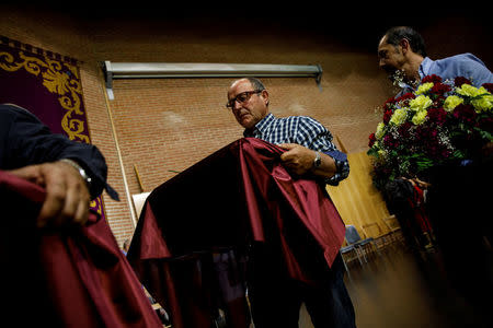 A relative of Isidoro Lozano Moreda who was shot in 1939 by forces of dictator Francisco Franco carries his remains during a ceremony in Guadalajara, Spain, May 19 , 2018. REUTERS/Juan Medina