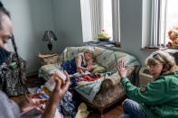 Sue Howland, right, and Larrecsa Cox, left, members of the Quick Response Team whose mission is to save every citizen who survives an overdose from the next one, help Betty Thompson, 65, who struggles with alcohol addiction, count her medications at her apartment in Huntington, W.Va., Wednesday, March 17, 2021. Thompson called that morning to say she needed help. With preexisting conditions that make her especially vulnerable to COVID, she'd been terrified she'd get the virus and die, and so she's drank more these months than she ever has before. (AP Photo/David Goldman)