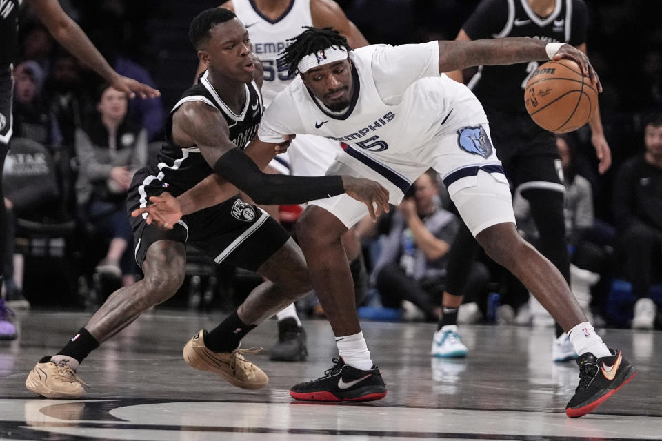 Memphis Grizzlies' Vince Williams Jr. (5) protects the ball from Brooklyn Nets' Dennis Schroder during the first half of an NBA basketball game, Monday, March 4, 2024, in New York. (AP Photo/Frank Franklin II)