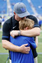 Kentucky head coach Mark Stoops hugs and kisses his son, Zack, after winning an NCAA college football game against Youngstown State in Lexington, Ky., Saturday, Sept. 17, 2022. (AP Photo/Michael Clubb)