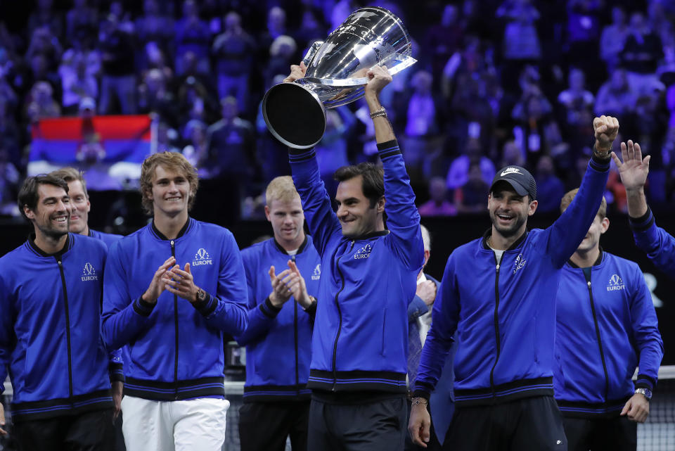 Team Europe's Roger Federer hoists the Laver Cup as he celebrates with teammates after defeating Team World in the Laver Cup tennis tournament, Sunday, Sept. 23, 2018, in Chicago. (AP Photo/Jim Young)