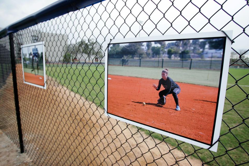 Photos of Amanda J. Buckley decorate the field fence during a dedication ceremony for the Amanda Buckley Memorial Field of Dreams in Palm Beach Gardens on Saturday, Feb. 9, 2008. Amanda, a member of the Palm Beach Gardens High School softball team, was murdered in July 2007.