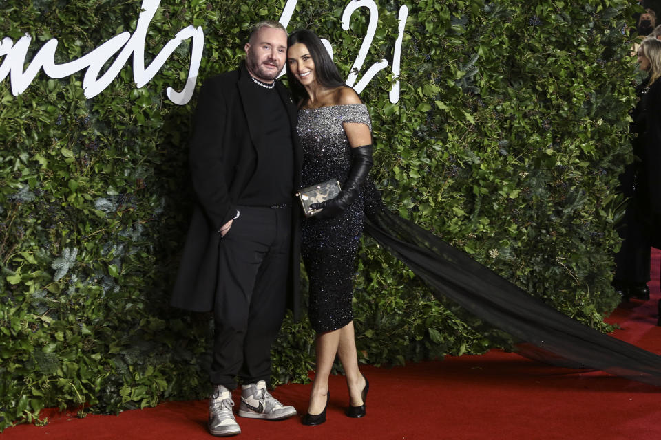 Kim Jones and Demi Moore pose for photographers upon arrival at the The Fashion Awards in London Monday, Nov. 29, 2021. (Photo by Joel C Ryan/Invision/AP)