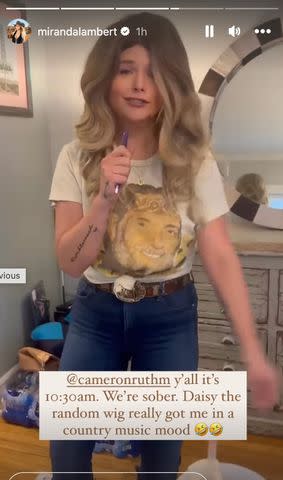<p>Miranda Lambert/Instagram</p> Miranda Lambert tries on the mystery wig she randomly received in her Amazon package
