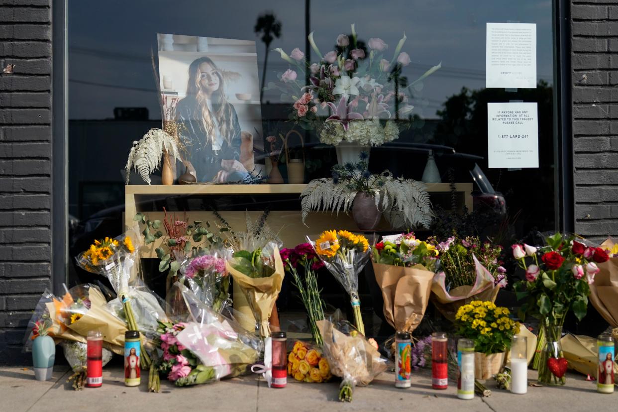 Flowers and candles are placed outside store in honor of Brianna Kupfer, pictured, on Jan. 18, 2022, in Los Angeles. 