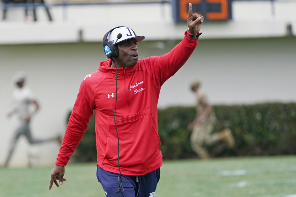 Jackson State football coach Deion Sanders calls out to his players during the first half of an NCAA college football against Edward Waters in Jackson, Miss., Sunday, Feb. 21, 2021. The game marks Sanders's collegiate head coaching debut. (AP Photo/Rogelio V. Solis)