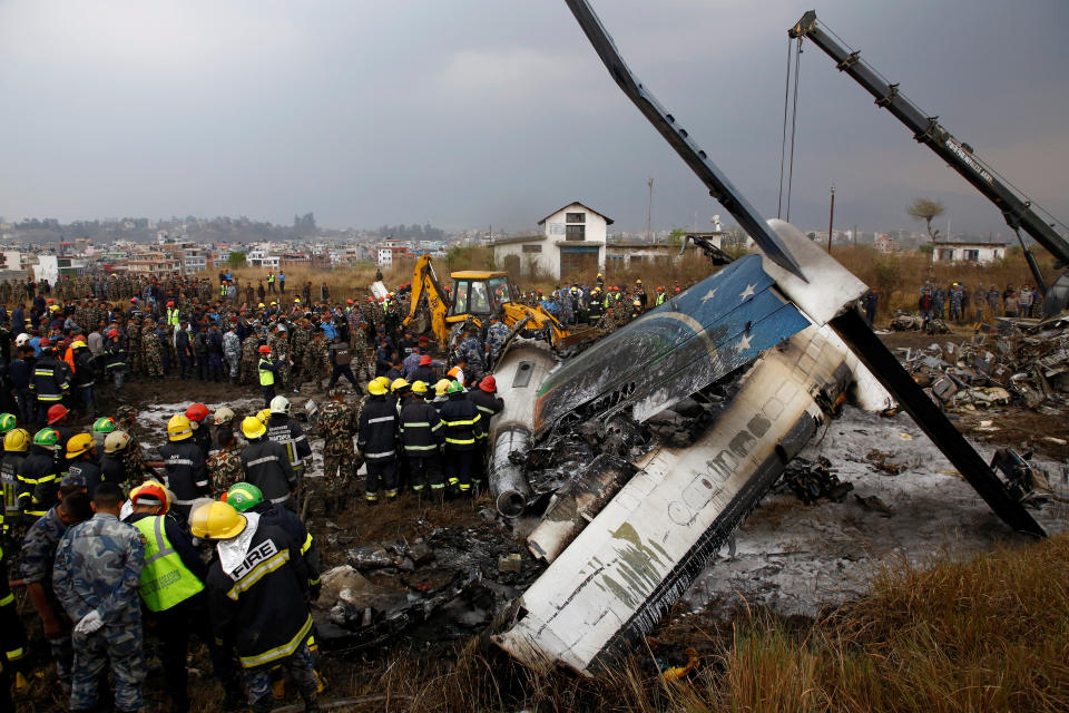 <p>Rescue workers work at the wreckage of a US-Bangla airplane after it crashed at the Tribhuvan International Airport in Kathmandu, Nepal, March 12, 2018. (Photo: Navesh Chitrakar/Reuters) </p>