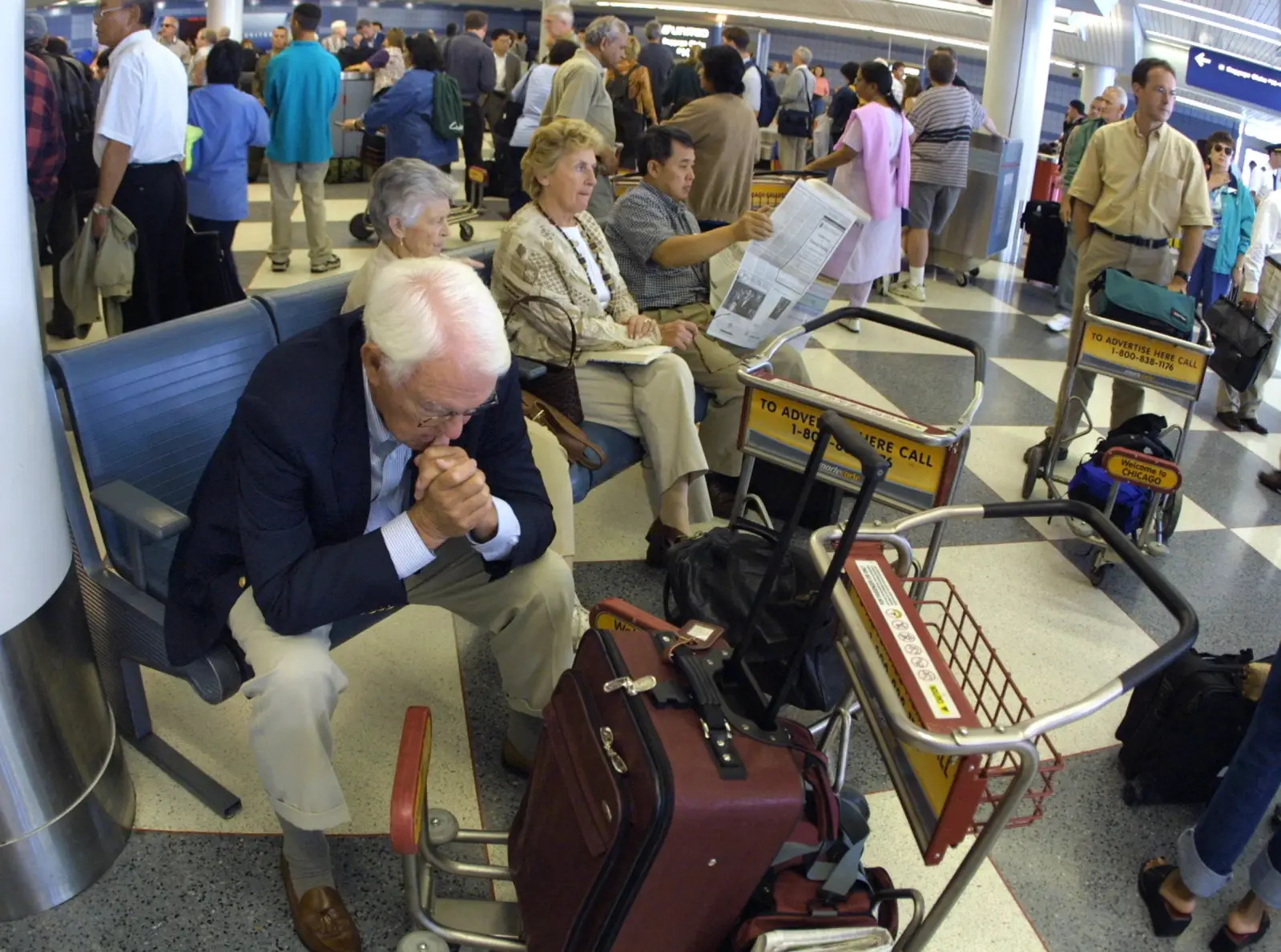 Viajeros varados en la terminal de United Airlines en el Aeropuerto Internacional O'Hare el 11 de septiembre de 2001, en Chicago, Illinois. Todo el tráfico aéreo en el aeropuerto se cerró después de los ataques al World Trade Center en la ciudad de Nueva York.