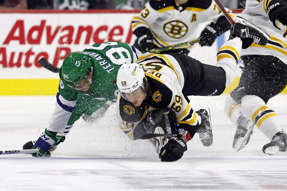 Carolina Hurricanes' Teuvo Teravainen collides with Boston Bruins' Tyler Bertuzzi (59) during the first period of an NHL hockey game in Raleigh, N.C., Sunday, March 26, 2023. (AP Photo/Karl B DeBlaker)