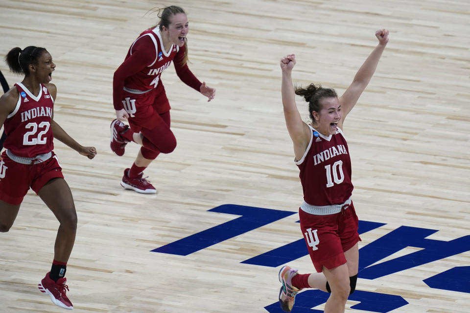 Indiana guard Chloe Moore-McNeil (22), guard Nicole Cardano-Hillary (4) and forward Aleksa Gulbe (10) celebrate their win over North Carolina State in a college basketball game in the Sweet Sixteen round of the women's NCAA tournament at the Alamodome in San Antonio, Saturday, March 27, 2021. (AP Photo/Eric Gay)