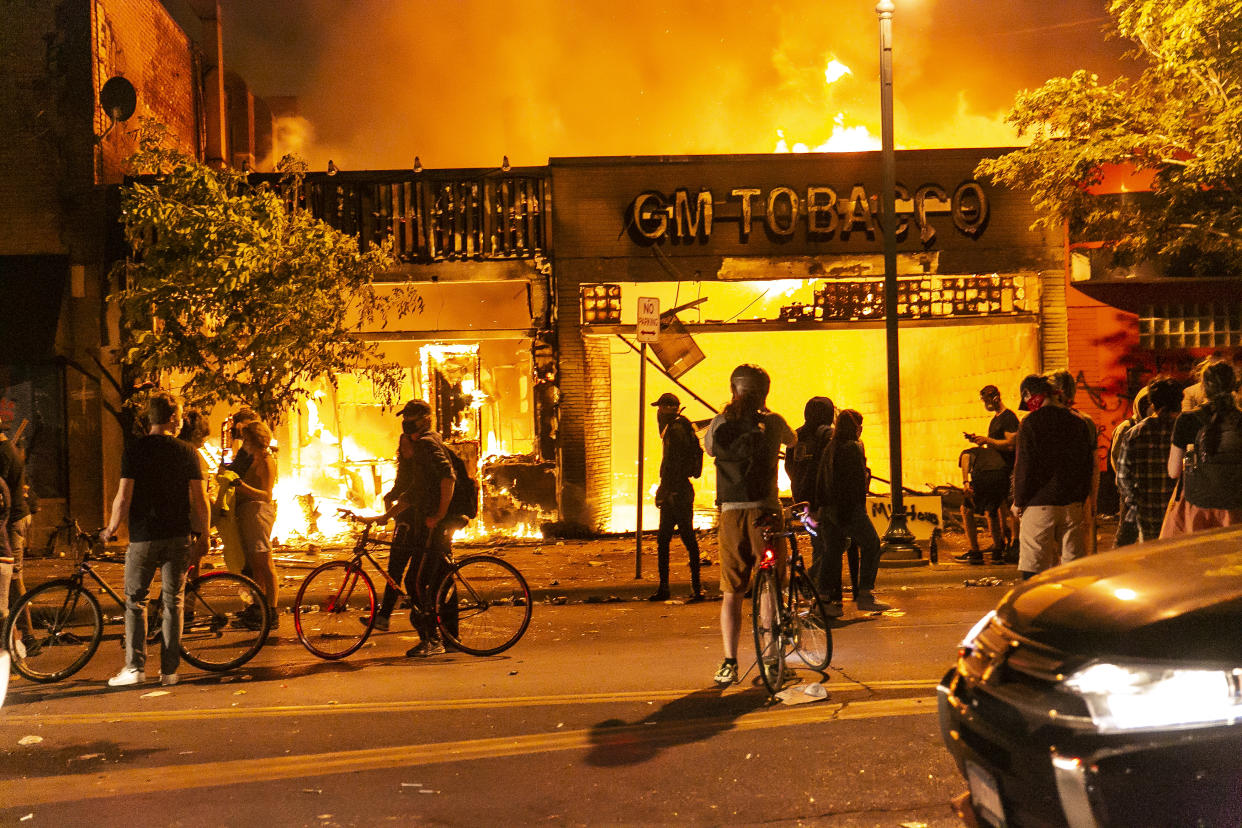 Protestors set a shop on fire on Thursday, May 28, 2020, during the third day of protests over the death of George Floyd in Minneapolis. Floyd died in police custody in Minneapolis on Monday night, after an officer held his knee into Floyd's neck for more than 5 minutes. (Jordan Strowder/Anadolu Agency via Getty Images)