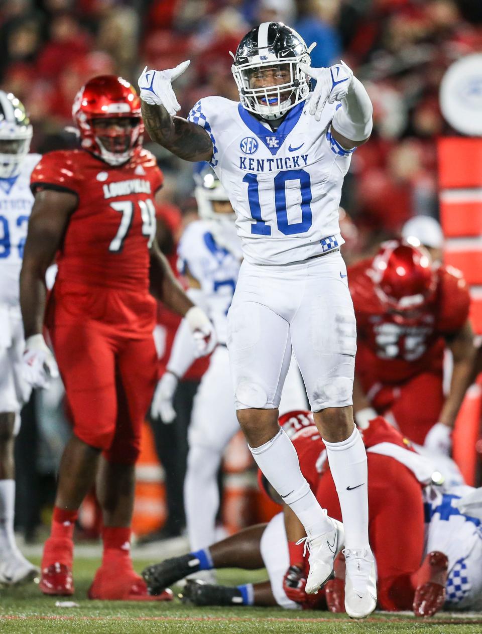 Kentucky's Jacquez Jones signals Ls down to the Cardinal crowd after stopping Louisville's Trevion Cooley for a loss in the second half as the Wildcats rolled past Louisville 52-21 Saturday night. Nov. 27, 2021 
