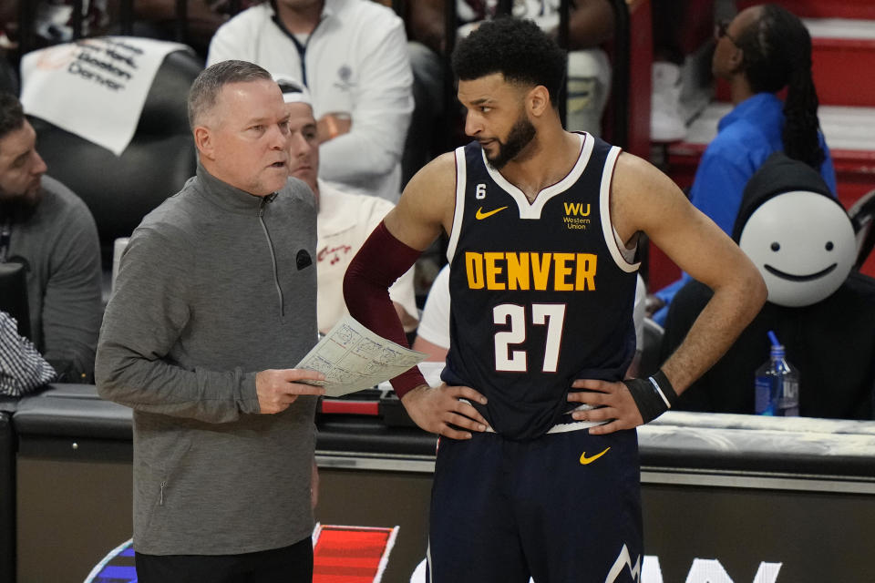 Denver Nuggets guard Jamal Murray (27) listens to head coach Michael Malone during the first half of Game 4 of the basketball NBA Finals against the Miami Heat, Friday, June 9, 2023, in Miami. (AP Photo/Lynne Sladky)