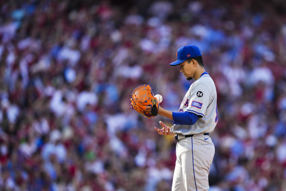 New York Mets pitcher Kodai Senga tosses a ball in between batters during the first inning of Game 1 of a baseball NL Division Series against the Philadelphia Phillies, Saturday, Oct. 5, 2024, in Philadelphia. (AP Photo/Matt Slocum)