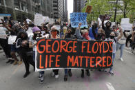 FILE - Protesters hold signs as they march during a protest over the death of George Floyd in Chicago, May 30, 2020. The 2020 death of George Floyd at the hands of Minneapolis police was a significant moment, forcing news organizations across the country to confront how they covered racial issues, both past and present, often at the prodding of their staff. (AP Photo/Nam Y. Huh, File)