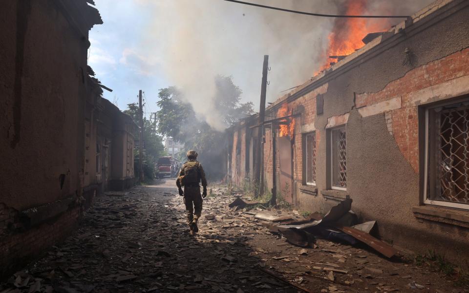 Fire burns at a shopping mall after it was struck by a missile - Scott Olson 