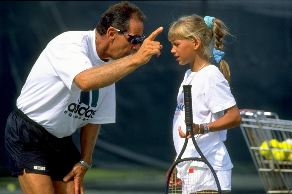 Nick Bollettieri gives instructions to a young Anna Kournikova of Russia during a training session (Getty Images)