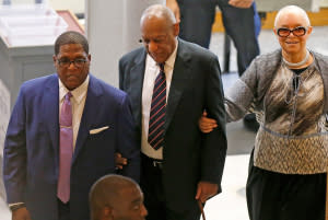 Bill Cosby (center) with his wife, Camille (right), in court on June 12.