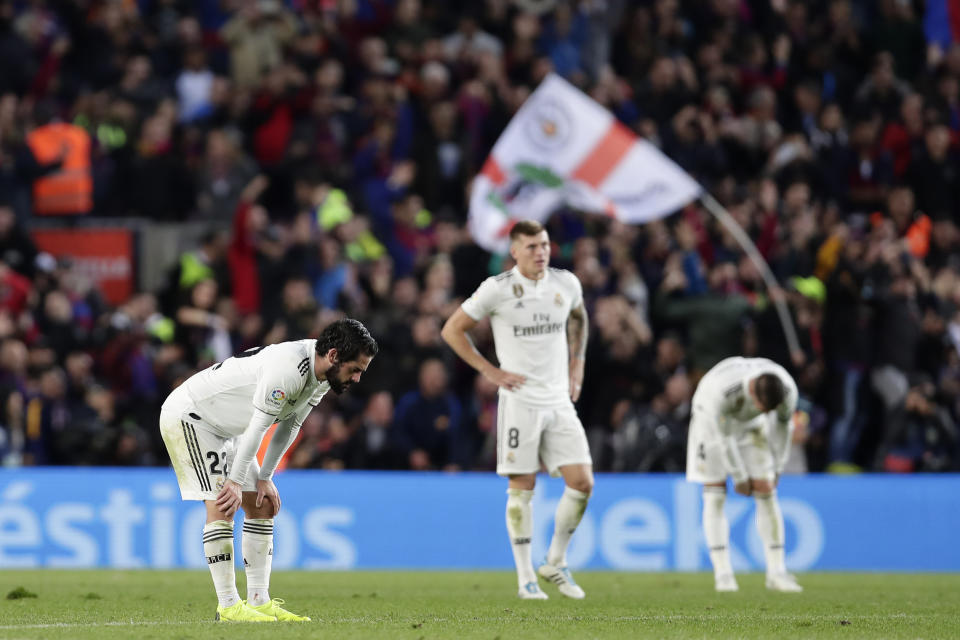 Real defender Sergio Ramos, right, Real midfielder Isco, left and Real midfielder Toni Kroos gesture after losing 5-1 during the Spanish La Liga soccer match between FC Barcelona and Real Madrid at the Camp Nou stadium in Barcelona, Spain, Sunday, Oct. 28, 2018. (AP Photo/Manu Fernandez)