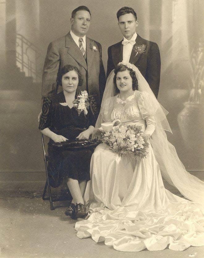 Aiello's great-grandparents, Domenico Aiello and Mariantonia Gatto Aiello, standing and seated at left, at the wedding of their son, Antonino Francesco Aiello, and his bride, Clara DiMarco, in Nutley in August 1942.