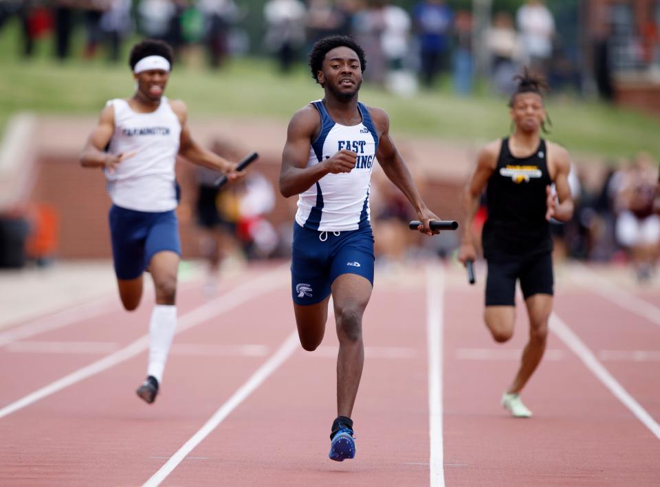 East Lansing, anchored by Donovan Patterson, center, wins the 4x200 meter relay, Saturday, June 4, 2022, at Rockford High School.