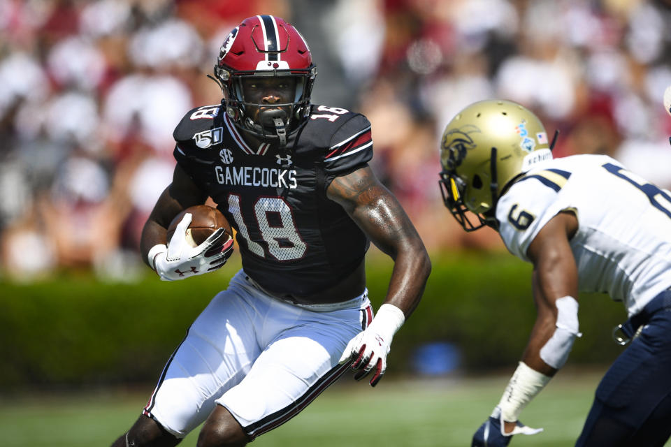 FILE - South Carolina wide receiver OrTre Smith (18) moves the ball as Charleston Southern defensive back Jarrod Stanley defends during the first half of an NCAA college football game in Columbia, S.C., in this Saturday, Sept. 7, 2019, file photo. Most of the top college football players who opted out of the 2020 season due to the pandemic decided to leave school and launch their pro careers. But plenty of other players who opted out of last season chose to continue their college careers either at their original school or opted to transfer. After opting out of last season, OrTre Smith is back and ready to regain the form he showed as a freshman. (AP Photo/John Amis, File)