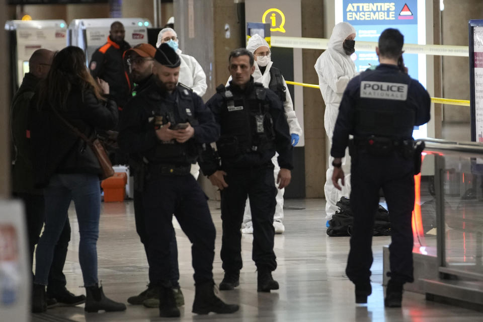 Police investigators work inside the Gare de Lyon station after an attack, Saturday, Feb. 3, 2024 in Paris. A man seemingly armed with a knife and a hammer injured three people Saturday in an early-morning attack at the major Gare de Lyon train station in Paris, another nerve-rattling security incident in the Olympic host city before the Summer Games open in six months. (AP Photo/Christophe Ena)