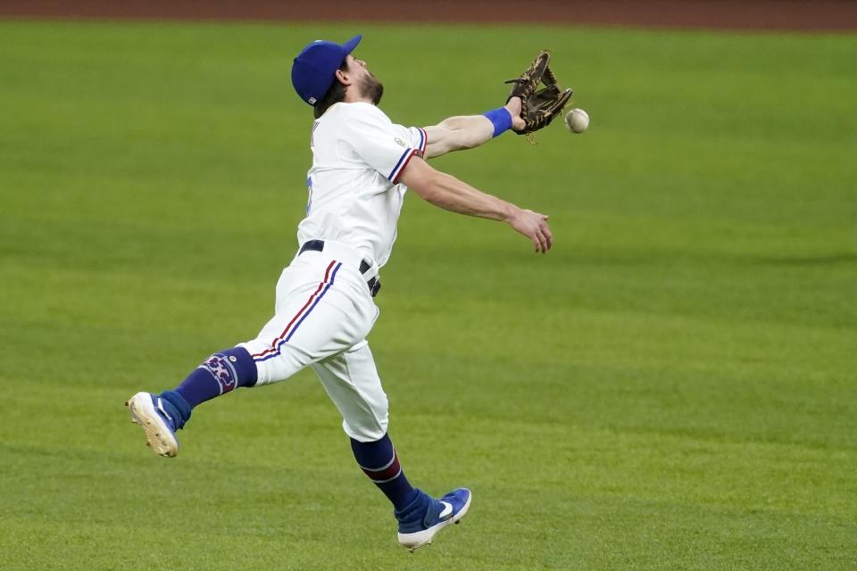 Texas Rangers second baseman Nick Solak is unable to reach a single hit by Houston Astros' Jose Altuve in the seventh inning of a baseball game in Arlington, Texas, Wednesday, Sept. 15, 2021. (AP Photo/Tony Gutierrez)