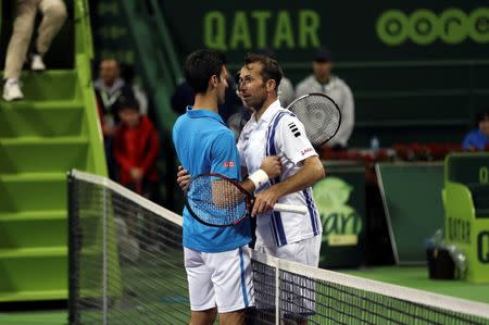 Tennis - Qatar Open - Men's Singles - Novak Djokovic of Serbia v Radek Stepanek of Czech Republic - Doha, Qatar - 5/1/2017 - Djokovic and Stepanek congratulate each other after their match. REUTERS/Ibraheem Al Omari