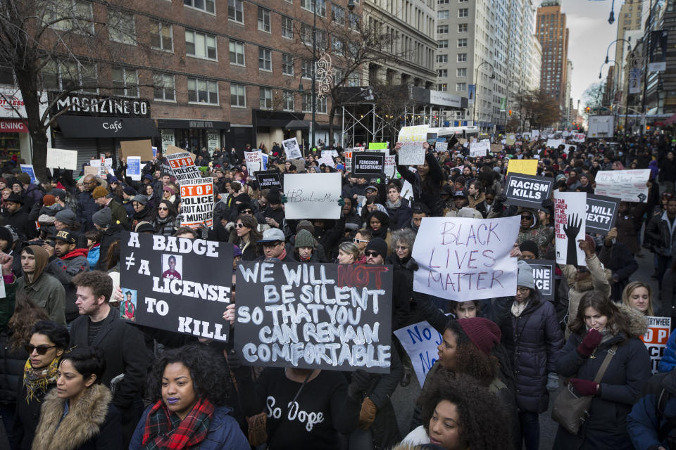 Demonstrators march in New York, Saturday, Dec. 13, 2014, during the Justice for All rally and march. In the past three weeks, grand juries have decided not to indict officers in the chokehold death of Eric Garner in New York and the fatal shooting of Michael Brown in Ferguson, Mo. The decisions have unleashed demonstrations and questions about police conduct and whether local prosecutors are the best choice for investigating police. (AP Photo/John Minchillo)