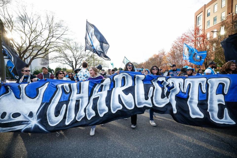 The banner for the fan march from the tailgate to the stadium is carried entirely by women before Charlotte FC’s match against the Columbus Crew on Saturday, March 23, 2024. Melissa Melvin-Rodriguez/mrodriguez@charlotteobserver.com