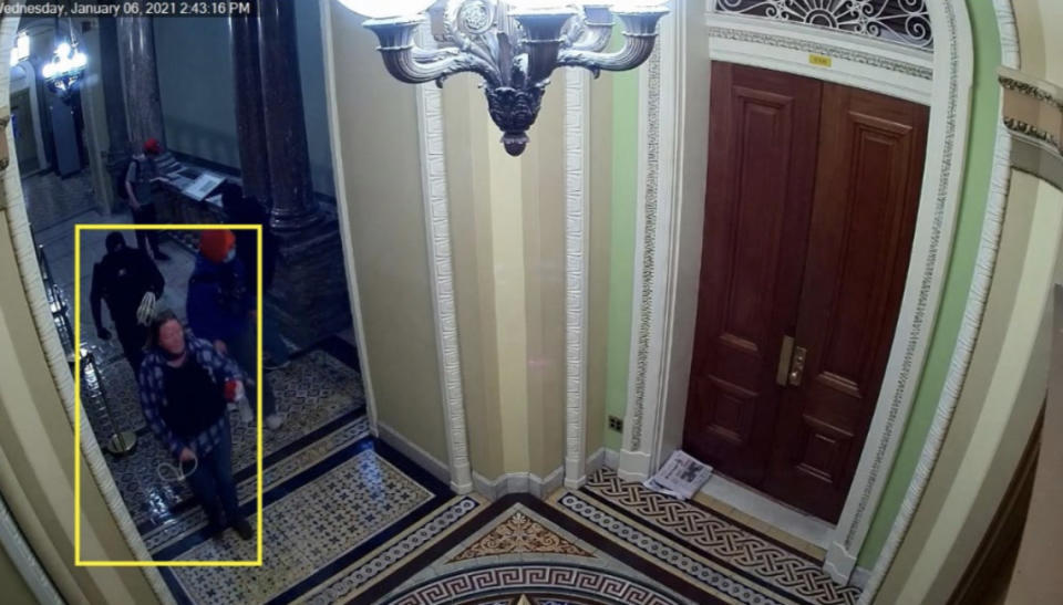 Image 8: Still from CCTV showing Munchel and Eisenhart walking the third-floor hallways with the zip ties in hand (Exhibit 506.2)