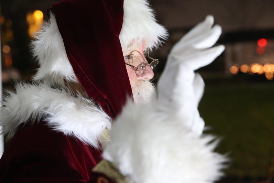 Santa Claus waves to cars during the Hudson Downtown Business Improvement District Wave-to-Santa event in front of Town Hall, Dec. 12, 2020.