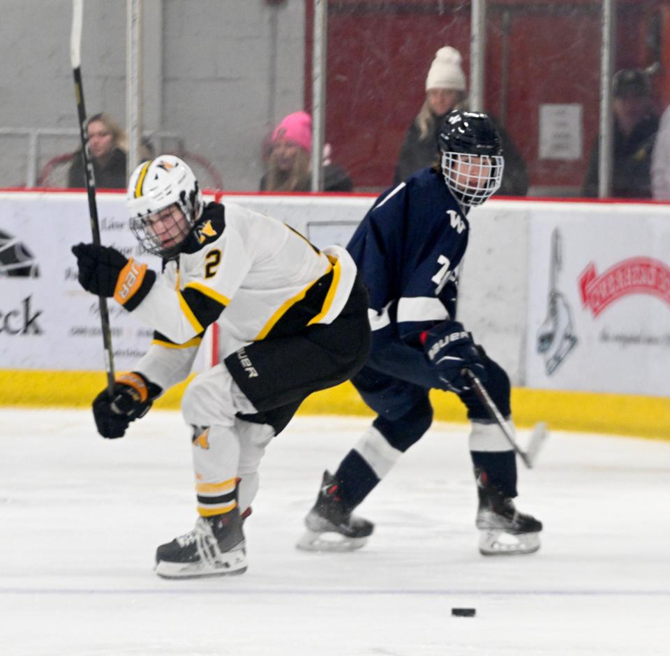 Colby O'Keefe of Nantucket and Matthew Swanson of Nauset turn on the puck.