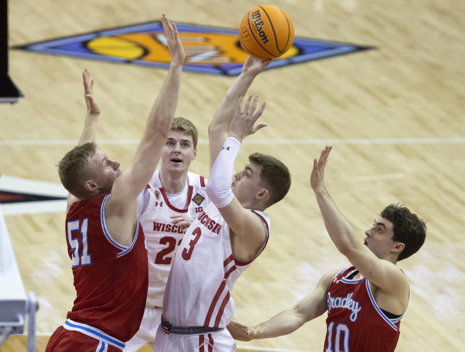Wisconsin guard Connor Essegian (3) shoots against Bradley forward Rienk Mast (51) during the first half of an NCAA college basketball game in the first round of the NIT in Madison, Wis., Tuesday, March 14, 2023. (Samantha Madar/Wisconsin State Journal via AP)